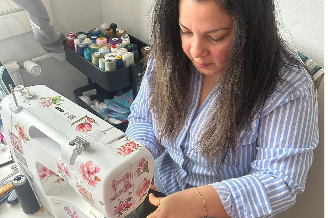Lady sewing a PopJoy corset in Helsinki atelier