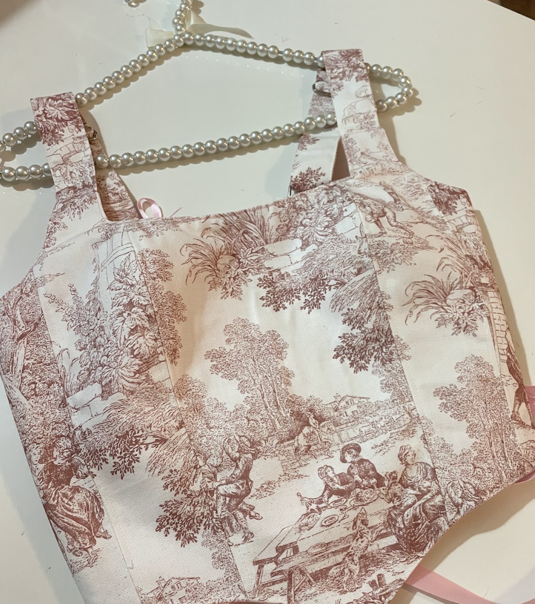 Vintage-style apron with intricate pattern on a white surface