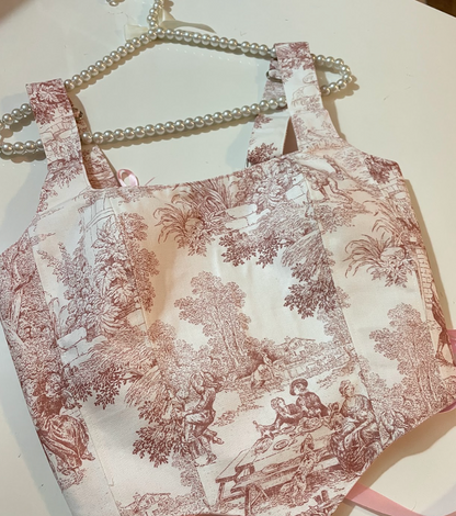 Vintage-style apron with intricate pattern on a white surface